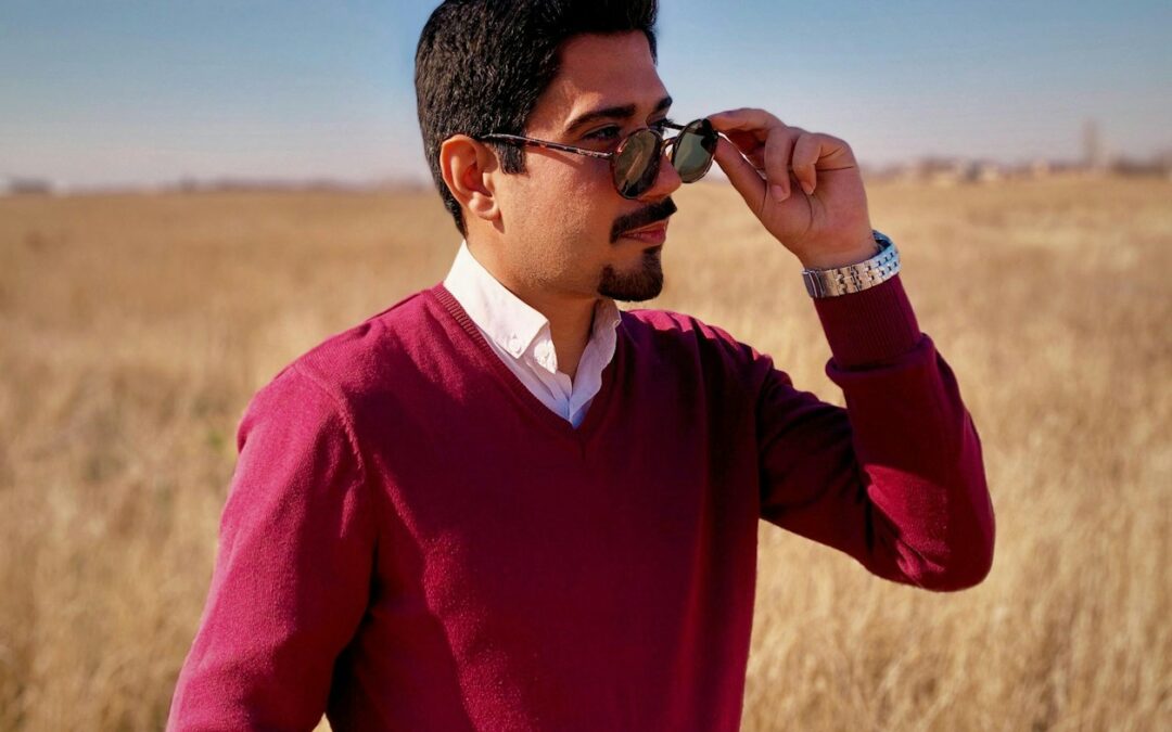 man in red sweater wearing black sunglasses