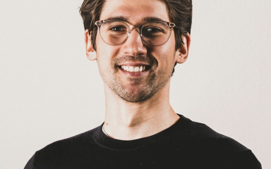 a man wearing glasses and a black shirt