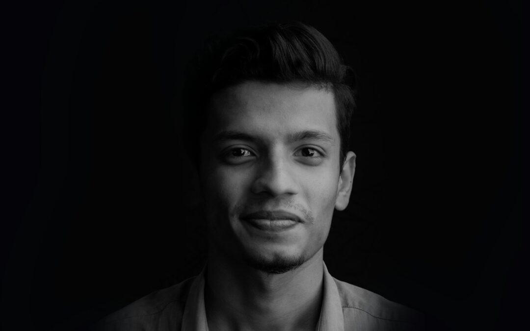 greyscale photo of smiling man wearing collared shirt
