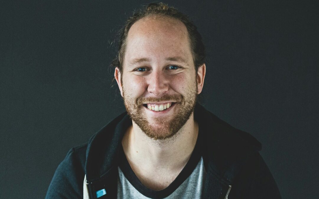 man in black jacket smiling